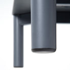 Close up image of the leg of a product showing the metal with powdercoat and protective foot glide. 