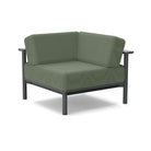 Studio image of a Corner Lounge Chair with Charcoal frame and Fern cushions.